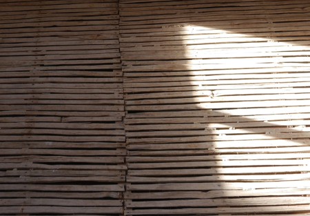 Wooden slats from a lath and plaster wall with natural sunlight.