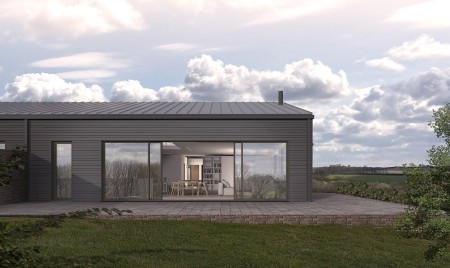 A converted barn. A modern building with metal clad roof and large glass sliding doors with the living space visable.